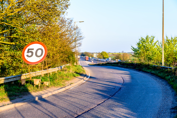 Signposts article image - a road with a 50 mph sign